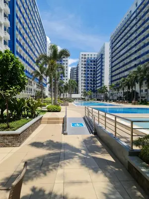 a swimming pool in a city with tall buildings at Sea Residences - Condo R Us in Manila