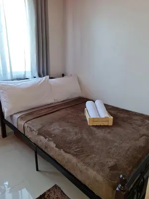 a bed sitting in a room with a window at Sea Residences - Condo R Us in Manila