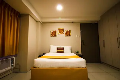 a bedroom with a large bed in a room at Jade Hotel and Suites in Manila