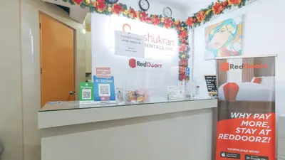 a store checkout counter with a holiday display at RedDoorz Plus near Tambo Paranaque in Manila