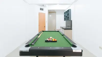 a pool table with a bowl of balls on it at RedDoorz Plus near Tambo Paranaque in Manila