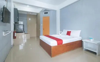 a bedroom with a bed and a tv in a room at RedDoorz Plus near Tambo Paranaque in Manila