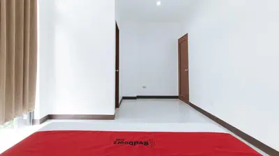 a room with a red rug on the floor and two doors at RedDoorz at Good 101 Paranaque in Manila