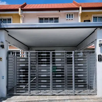 a garage with metal doors in front of a house at Transient Home at Tierra Vista near SM Dasma with Wifi and Netflix in Mabatang