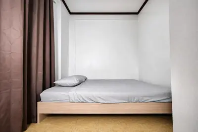 a small bed in a room with a window at Transient Home at Tierra Vista near SM Dasma with Wifi and Netflix in Mabatang
