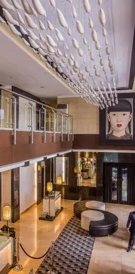 a living room with a large chandelier in a building at Y2 Residence Hotel Managed by HII in Manila