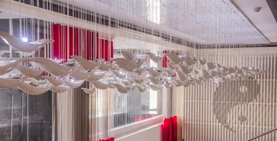 a chandelier hanging from the ceiling in a room at Y2 Residence Hotel Managed by HII in Manila