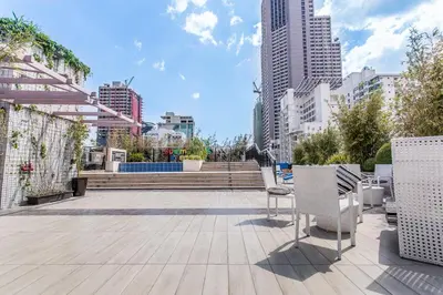 a patio with chairs and stairs in a city at Y2 Residence Hotel Managed by HII in Manila