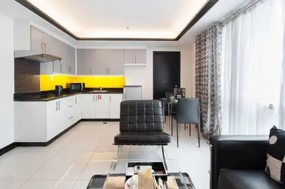 a kitchen and living room with a couch and a table at Y2 Residence Hotel Managed by HII in Manila