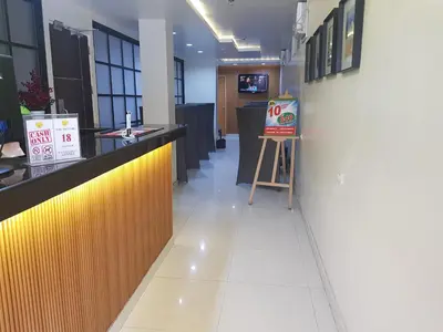 a restaurant with a counter with a sign on it at My Inn Calamba in Calamba