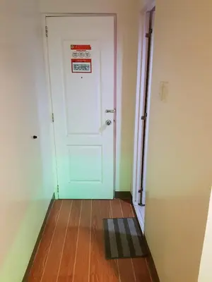 a room with a door and a wooden floor at My Inn Calamba in Calamba