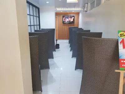 a row of chairs in a room with a hallway at My Inn Calamba in Calamba
