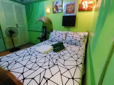 a bedroom with a bed with a black and white at Cubao Quezon city Transient condo unit in Manila