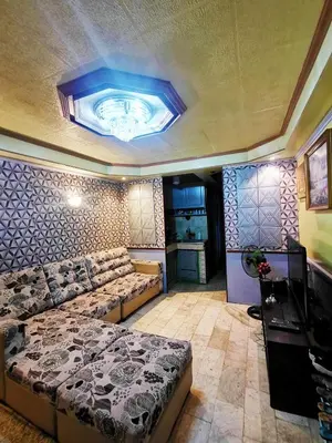 a living room with a couch and a bed at Cubao Quezon city Transient condo unit in Manila