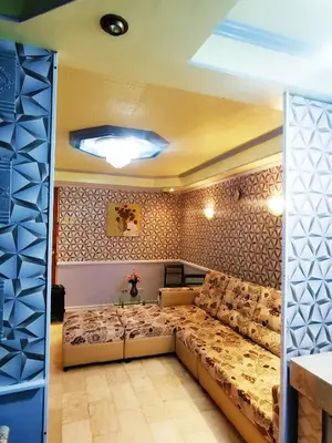 a living room with a large couch in a room at Cubao Quezon city Transient condo unit in Manila