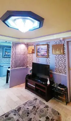 a living room with a flat screen tv on a wall at Cubao Quezon city Transient condo unit in Manila