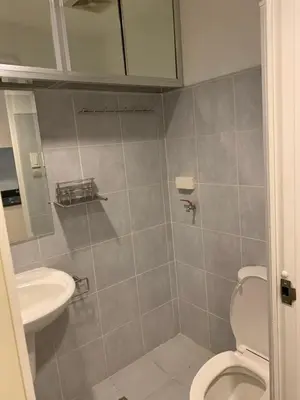 a bathroom with a toilet and a sink at Wind and Sea at Sea Residences in Manila