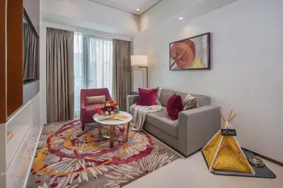 a living room with a couch and a table at Somerset Central Salcedo Makati in Manila