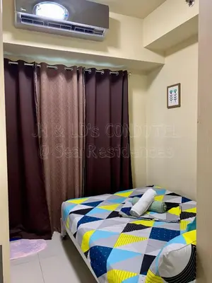a bedroom with a bed in a room at Sea Residences by JH & LD's Condotel in Manila