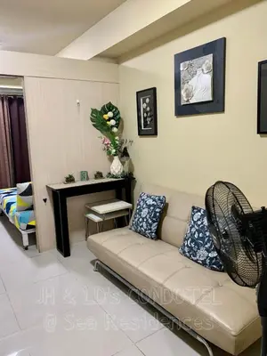 a living room with a couch and a table at Sea Residences by JH & LD's Condotel in Manila