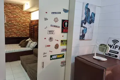 a refrigerator in a room with stickers on the wall at CENTROPOLIS 4, Fun & Playful in Manila