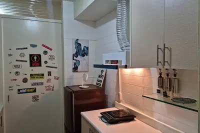 a kitchen with a refrigerator with stickers on it at CENTROPOLIS 4, Fun & Playful in Manila