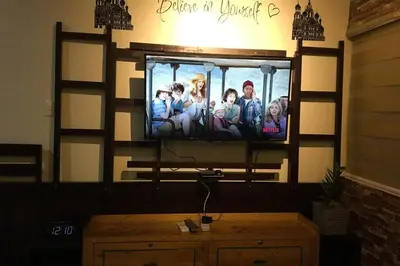 a flat screen tv on a wall in a living room at CENTROPOLIS 4, Fun & Playful in Manila