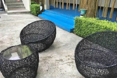 three black trash cans sitting in front of a building at CENTROPOLIS 3, Tropical Modern in Manila