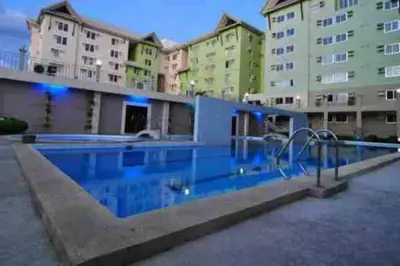 a large swimming pool in front of a building at CENTROPOLIS 3, Tropical Modern in Manila