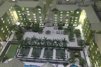 an overhead view of a building with a courtyard with palm trees at CENTROPOLIS 3, Tropical Modern in Manila