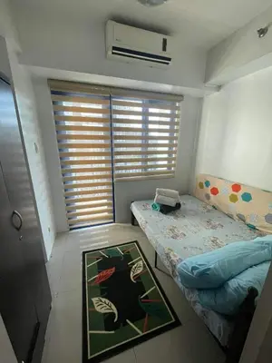 a small room with a bed and a window at Sea Residences at Jireh in Pasay