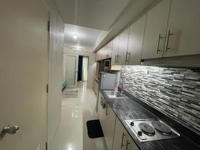 a small kitchen with a sink and a counter top at Sea Residences at Jireh in Pasay