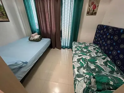 a small room with a bed and a couch at Sea Residences at Jireh in Pasay