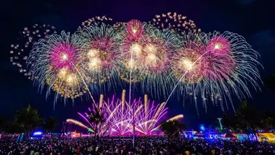 a crowd of people watching a fireworks show at night at Sea Residences at Jireh in Pasay
