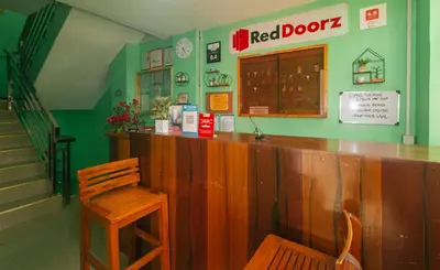 a bar in a restaurant with a wooden counter and a chair at RedDoorz near EDSA Camp Crame in Manila
