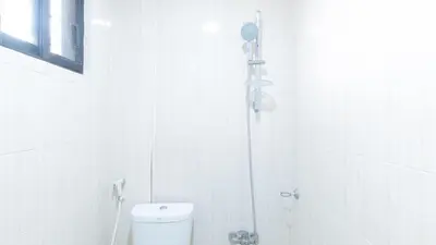 a white bathroom with a shower and a toilet at RedDoorz at RJs Bldg near Lyceum Gen Trias Cavite Cion Suites in General Trias