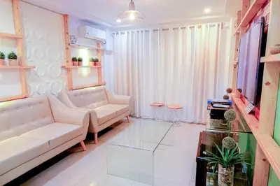 a living room with a couch and a tv at House of Citiflora Unit A in Manila