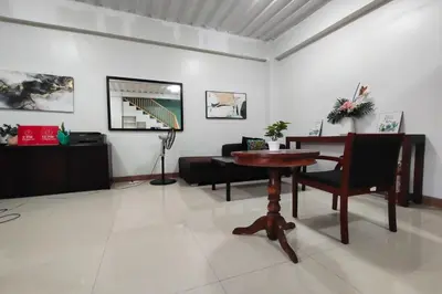 a living room with a table and a couch at La Belladoza near NAIA T1 Airport in Manila