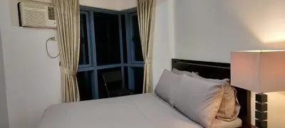 a bedroom with a white bed with a window at Magnificent View of Manila Bay, Roxas Blvd, US Embassy in Manila