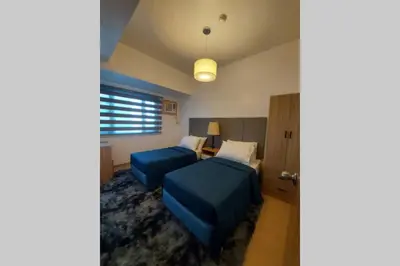 a hotel room with two beds and a table at Magnificent View of Manila Bay, Roxas Blvd, US Embassy in Manila