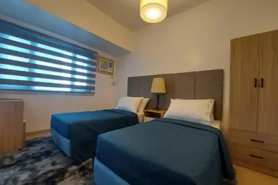 a bedroom with two beds and a window at Magnificent View of Manila Bay, Roxas Blvd, US Embassy in Manila