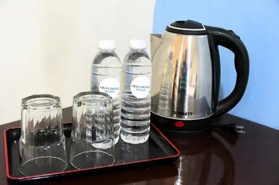 a tray with water bottles and glasses on a table at Arzo Hotel Makati in Manila