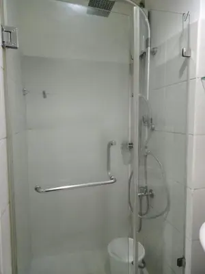 a shower with a glass door in a bathroom at SEA RESIDENCES F in Manila