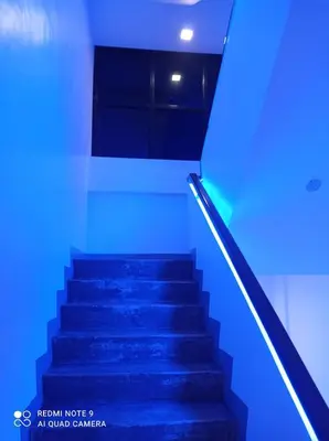 a staircase with blue lights in a building at 8 Zhensen Inn in Bacoor