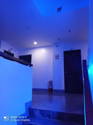 a room with blue lights and a black door at 8 Zhensen Inn in Bacoor
