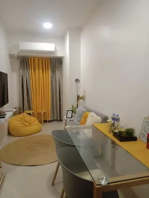 a living room with a glass table and a couch at Family Suite Staycation FAME Residence 1508 Tower1 in Manila