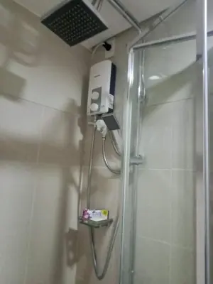 a bathroom with a shower stall with a shower at Family Suite Staycation FAME Residence 1508 Tower1 in Manila