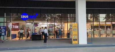 a man standing in front of a store window at Family Suite Staycation FAME Residence 1508 Tower1 in Manila
