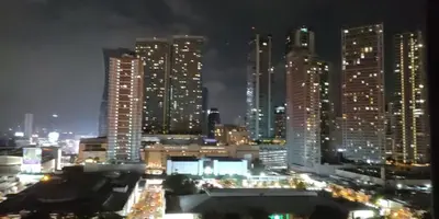 a city skyline at night with tall buildings at Family Suite Staycation FAME Residence 1508 Tower1 in Manila