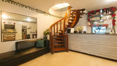a restaurant with a bar with a couch and a counter at Nearest Hostel Pasay City by RedDoorz in Manila